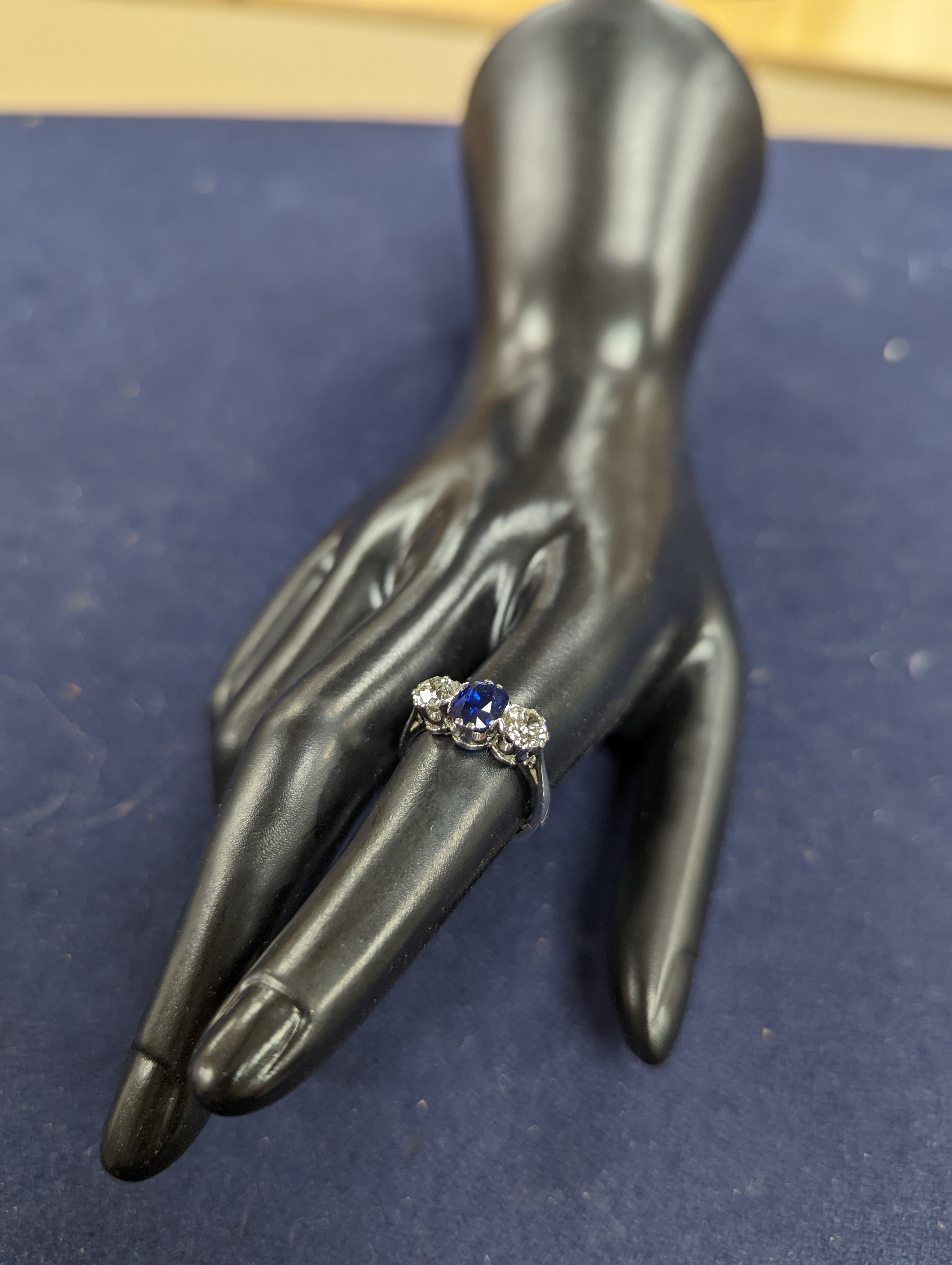 A modern 18ct white gold, single stone sapphire and two stone diamond set ring, size L, gross weight 4.2 grams